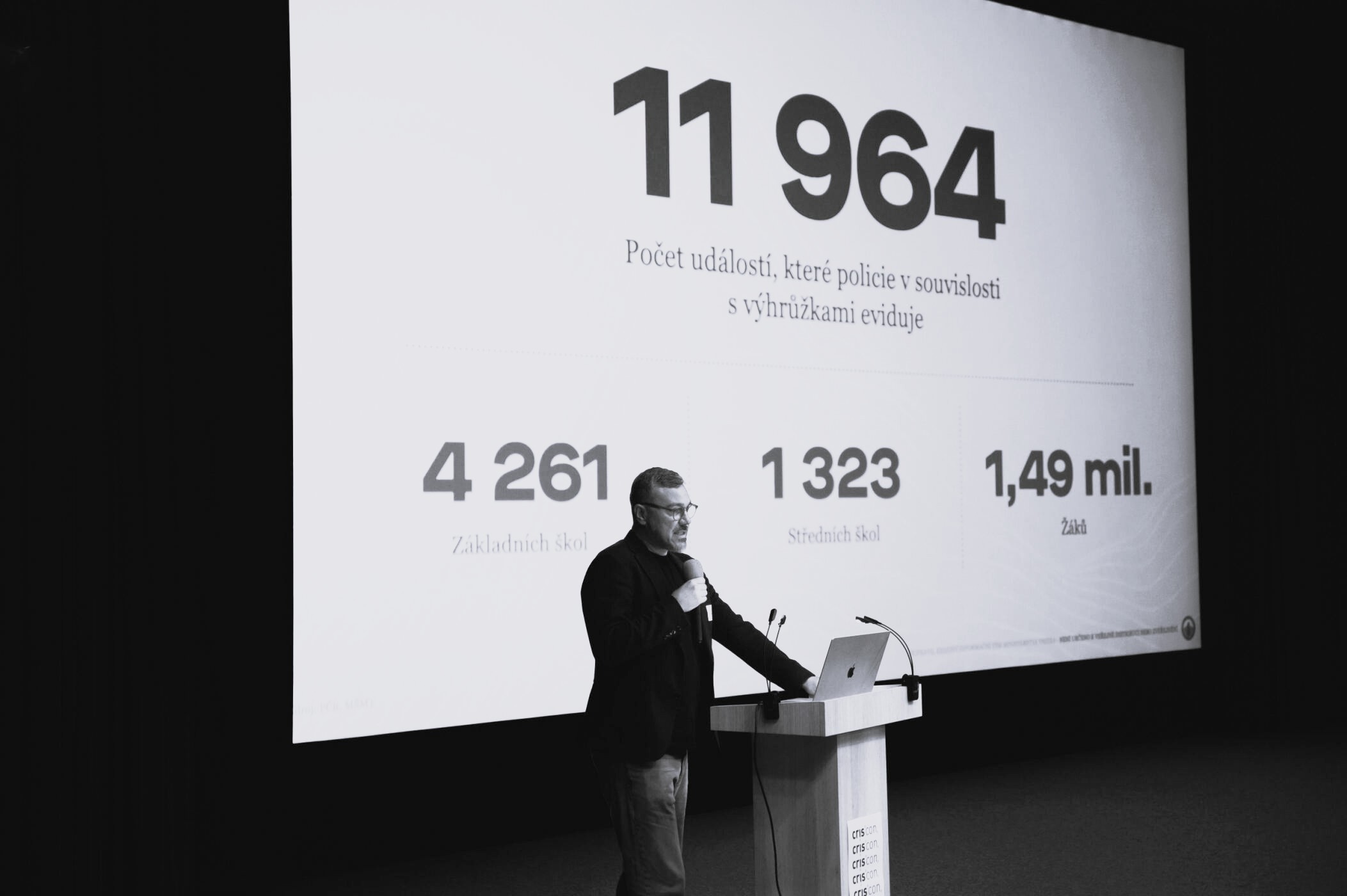 Speaker at podium with statistics
